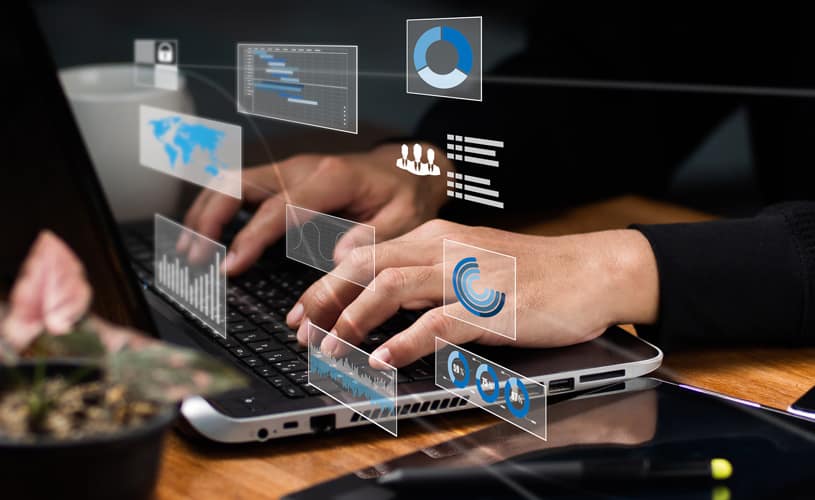 Hands over a keyboard with digital representations of charts and icons to give an idea of a customer experience strategy.