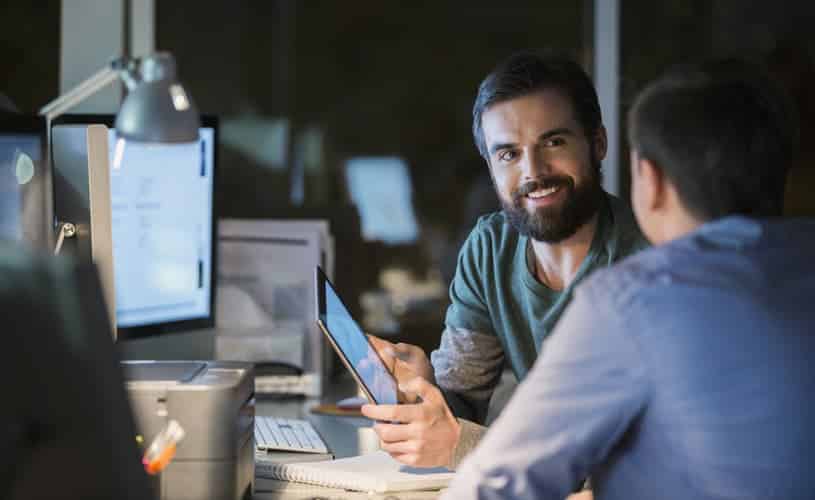 people chatting in an office about data analytics and how to tell a great data story