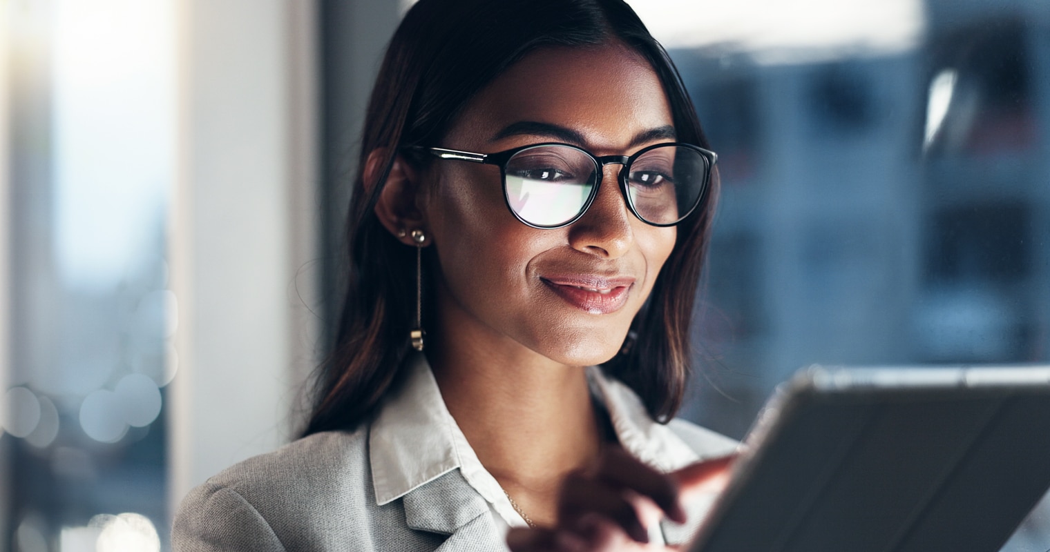 A focused woman with glasses researching "what is a terabyte"