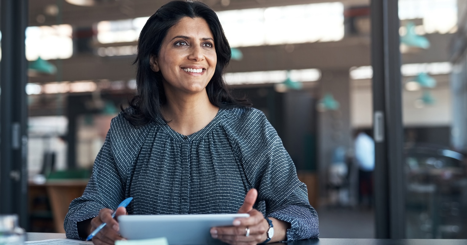 Smiling professional woman with a tablet, possibly studying machine learning modeling