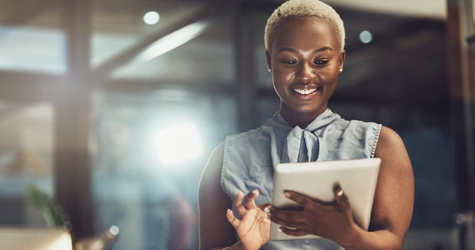 Smiling woman using a tablet, likely researching What is RDD