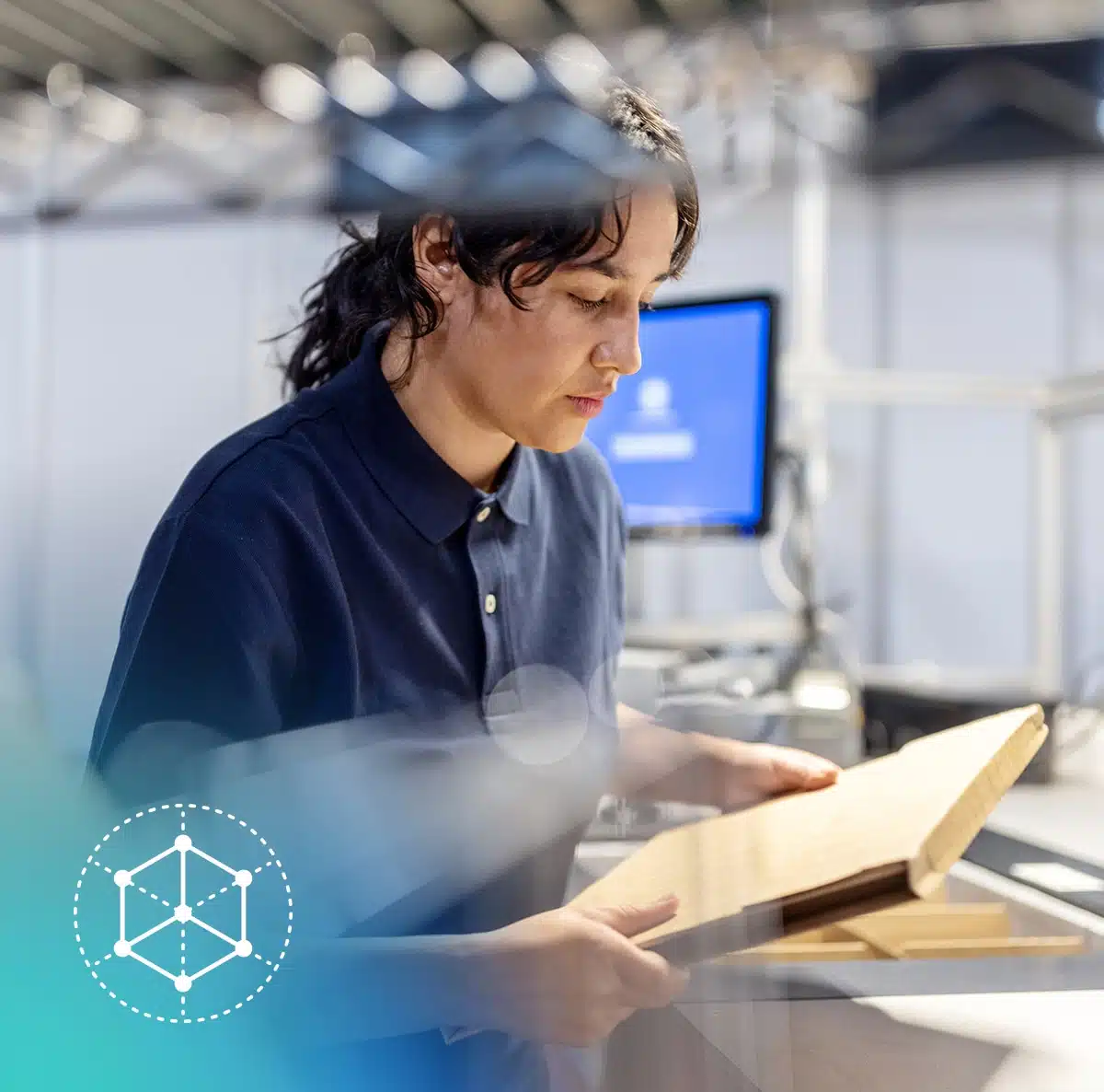 woman in a manufacturing facility utilizing the data intelligence platform to unlock value from data